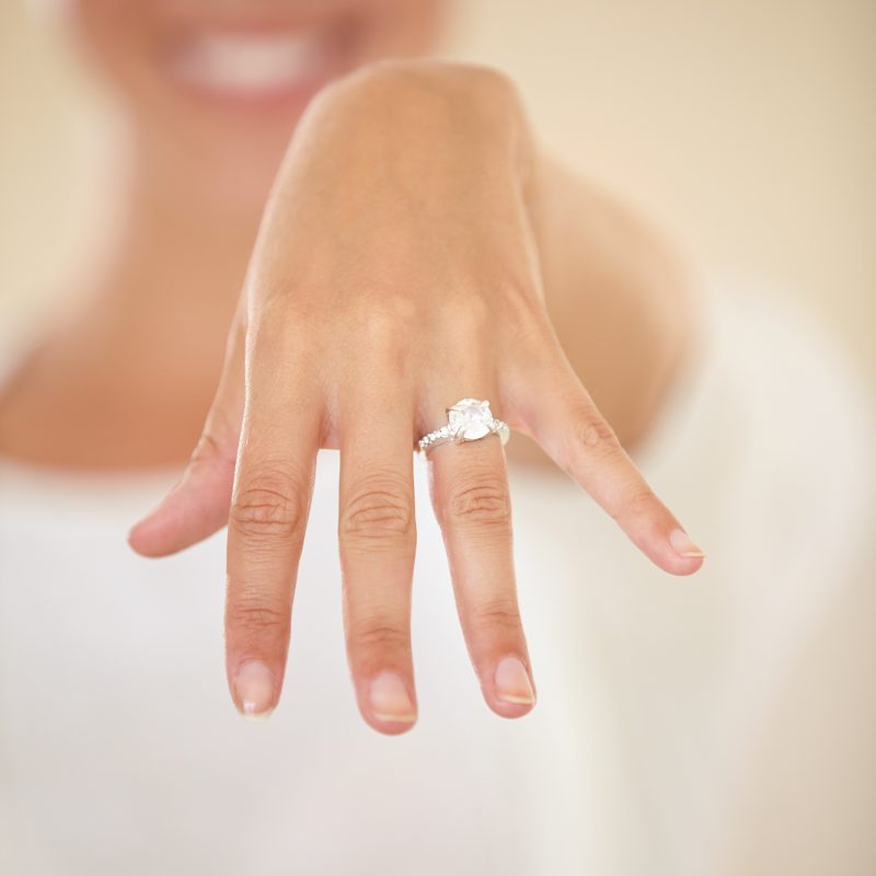 round-eye-clean-diamond-engagement-ring-on-womans-hand